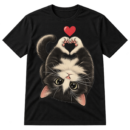 Upside-down fluffy black kitten with raised paws forming a heart and a small red heart overhead.