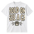 Handwritten text reading “HOLD ON. I SEE A CAT.” with a small sketched paw print underneath.